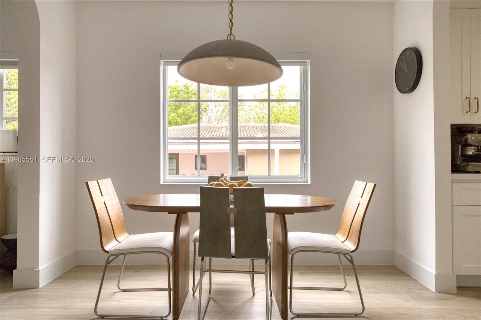 A dining area features a wooden table, four chairs, a pendant light, and a window — 2397 SW 13th St, Miami FL 33145, MIAMI, FL