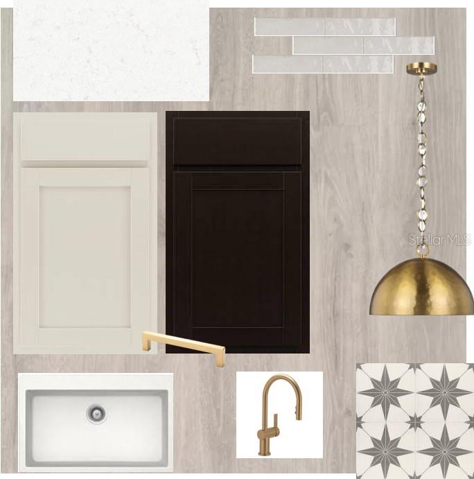 A modern kitchen with white cabinets, a dark island, and light wood-look flooring — 15239 EASTLYN DRIVE, BRADENTON, FL