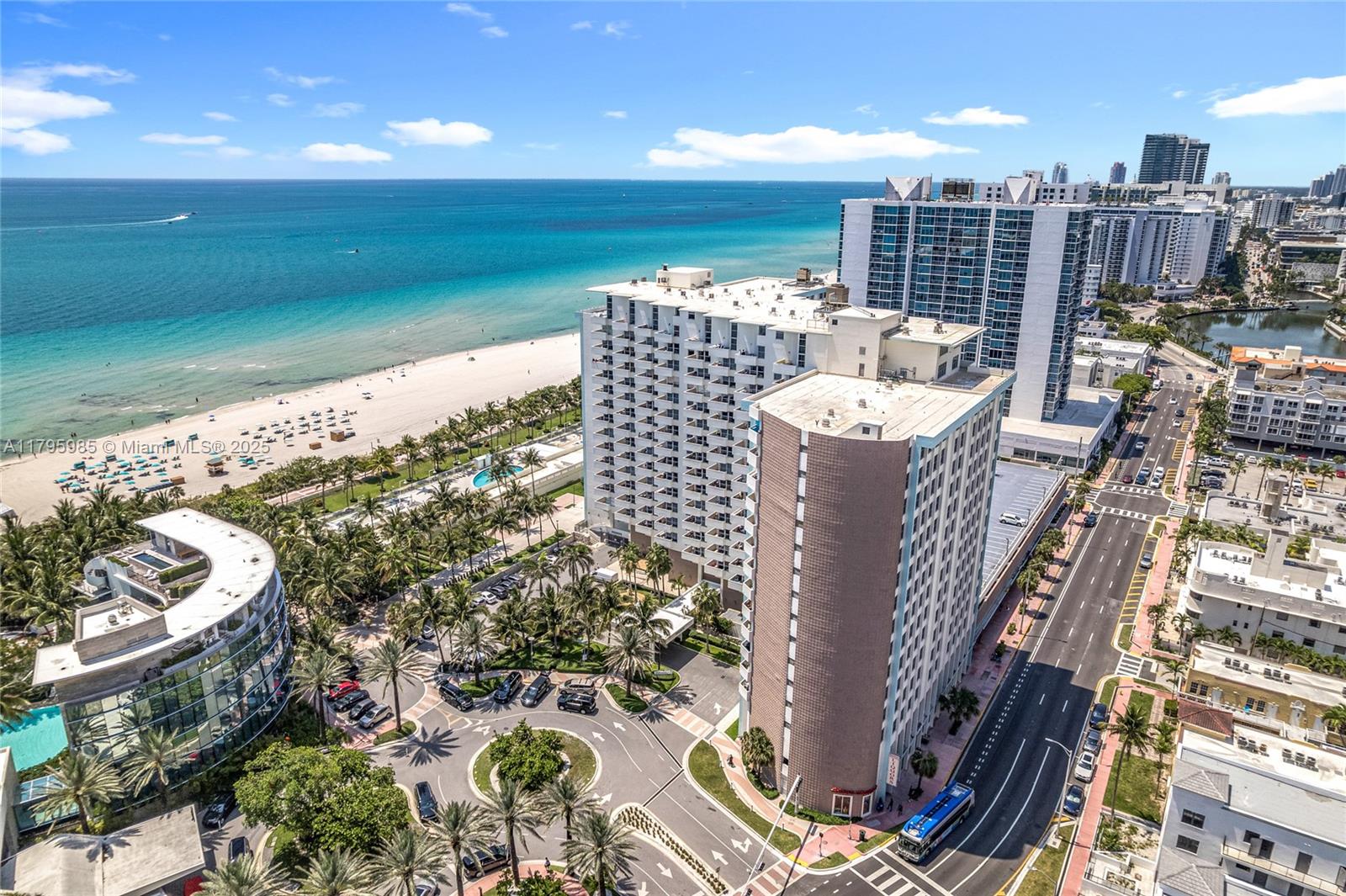 An aerial view shows high-rise apartment buildings located along a sandy beach and oceanfront — 2899 Collins Ave # 1218, Miami Beach FL 33140, MIAMI BEACH, FL