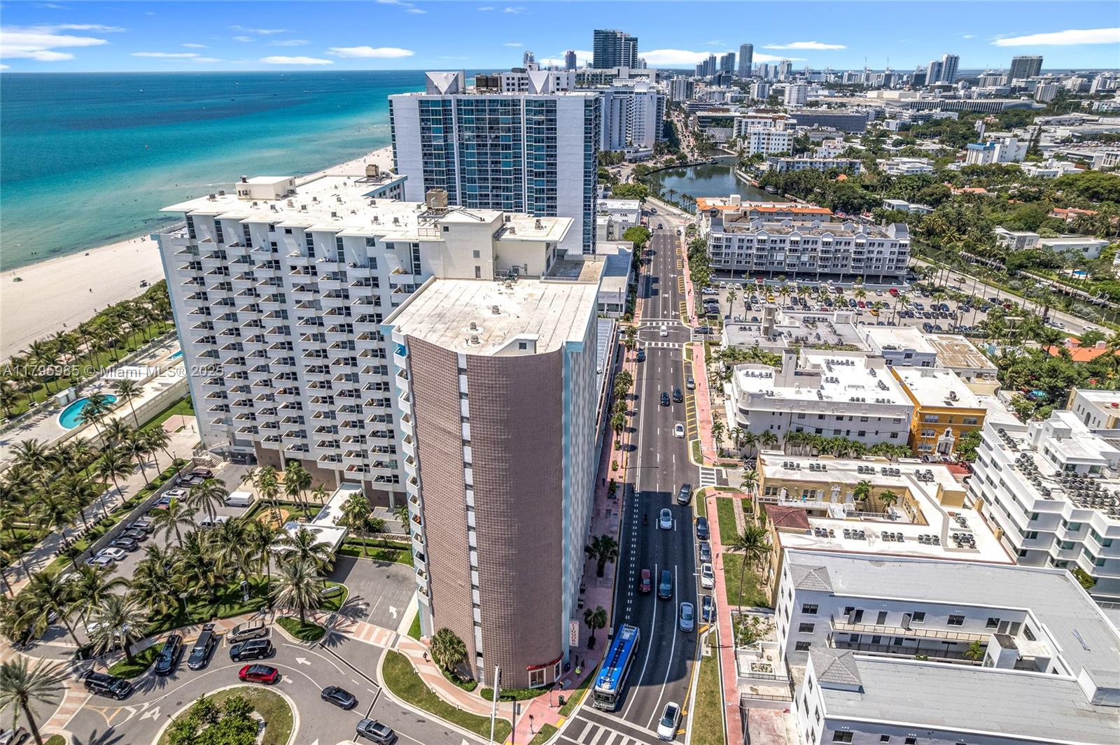 An aerial view shows high-rise apartment buildings along a beach and a city street — 2899 Collins Ave # 1218, Miami Beach FL 33140, MIAMI BEACH, FL