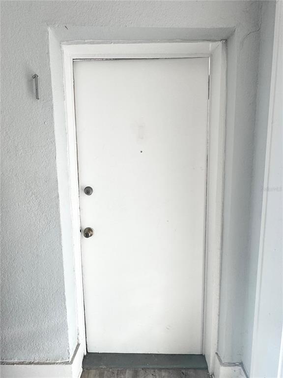 A white exterior door labeled with the number one is set in a gray wall — 704 CORDOVA DRIVE UNIT 1, ORLANDO, FL
