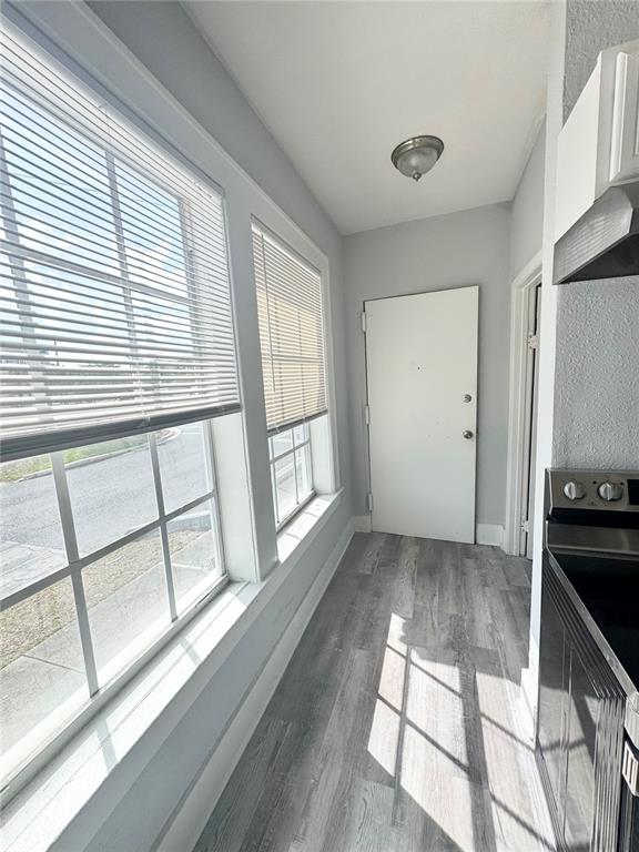 A narrow kitchen area features gray wood-look flooring, white walls, and two large windows — 704 CORDOVA DRIVE UNIT 1, ORLANDO, FL