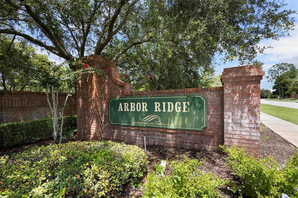 A brick entrance sign for a community named Arbor Ridge stands among trees and landscaping — 3152 WOOD ROSE WAY, DELTONA, FL