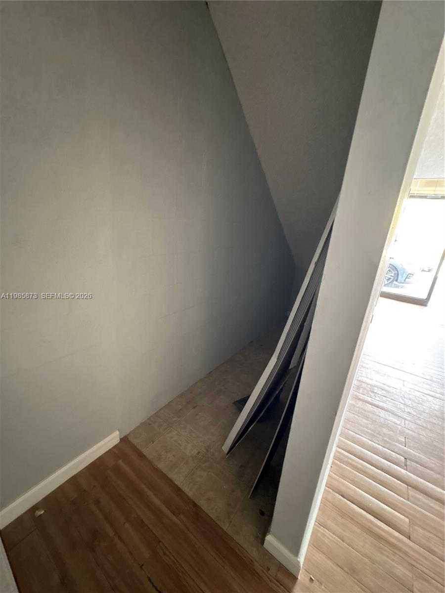 An interior view shows a small, unfinished alcove with gray walls and a tiled floor — 13008 SW 120th St # 5, Miami FL 33186, MIAMI, FL