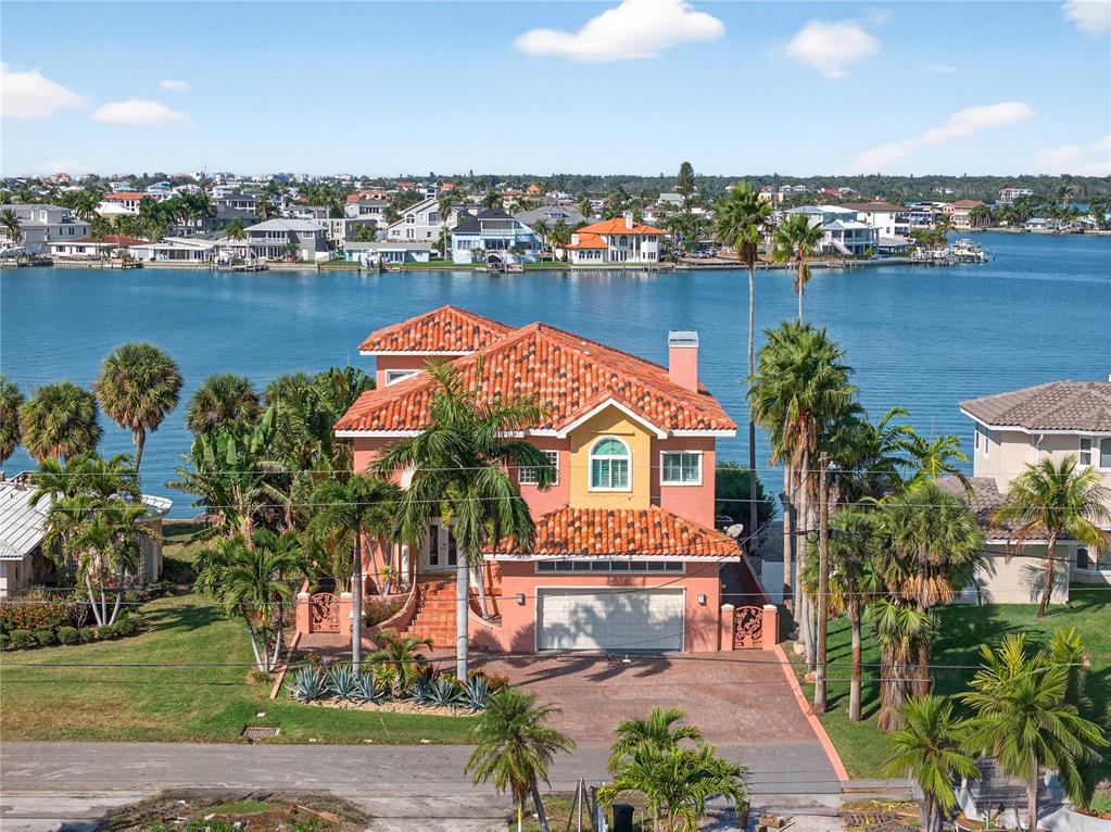 A view of a boat dock with a docked vessel extending into a calm bay — 16480 REDINGTON DRIVE, REDINGTON BEACH, FL