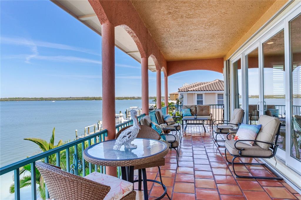 An aerial view of a multi-story, peach-colored waterfront home with a red tile roof — 16480 REDINGTON DRIVE, REDINGTON BEACH, FL