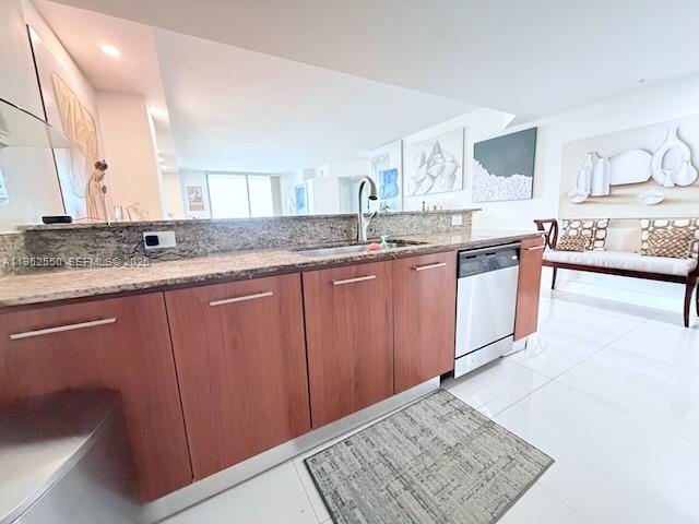 A kitchen features wood cabinets, granite countertops, and a stainless steel dishwasher — 9066 SW 73rd Ct # 1105, Miami FL 33156, MIAMI, FL