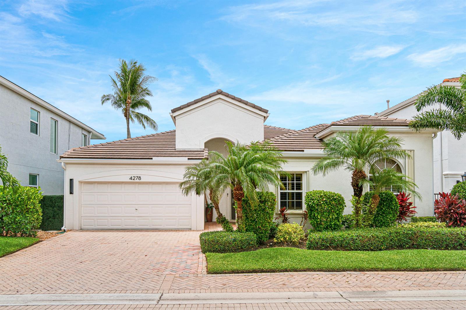 A single-story house with a white exterior, a two-car garage, and palm trees in front — 4278 NW 65th Road, Boca Raton FL 33496, BOCA RATON, FL