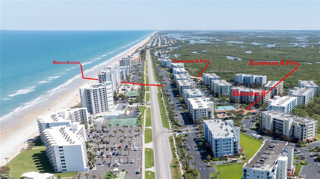 This aerial view shows a coastal resort complex with multiple buildings, parking lots, and beach access — 5300 S ATLANTIC AVENUE UNIT 8-304, NEW SMYRNA BEACH, FL