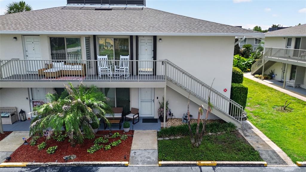 An exterior view of a two-story apartment building with a balcony and outdoor staircase — 1935 CONWAY ROAD UNIT L5, ORLANDO, FL
