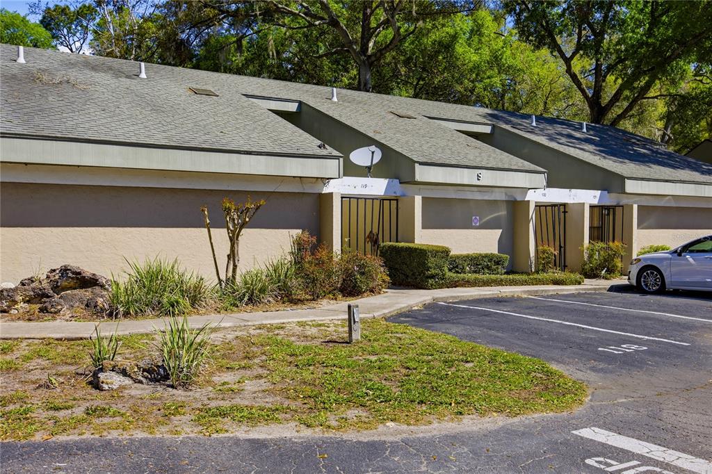 A single-story apartment building with a gray shingled roof and a paved parking lot — 7200 SW 8TH AVENUE UNIT S119, GAINESVILLE, FL