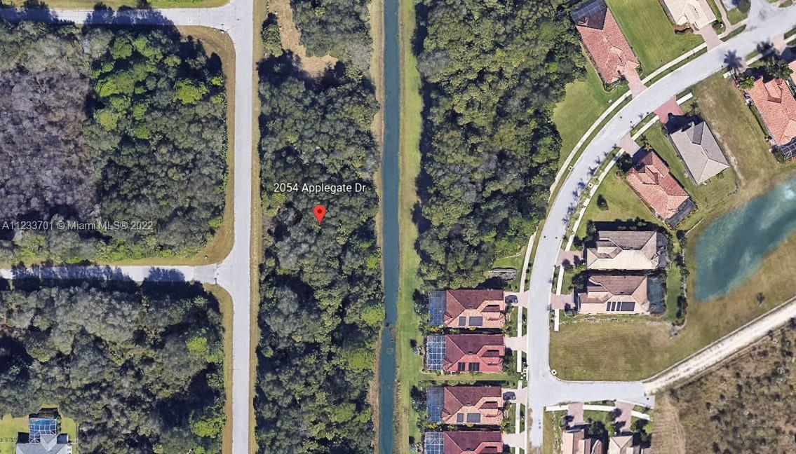 This aerial map shows a wooded lot adjacent to a canal and residential neighborhood — 2054 Applegate Ave, Port Charlotte FL 33953, PORT CHARLOTTE, FL