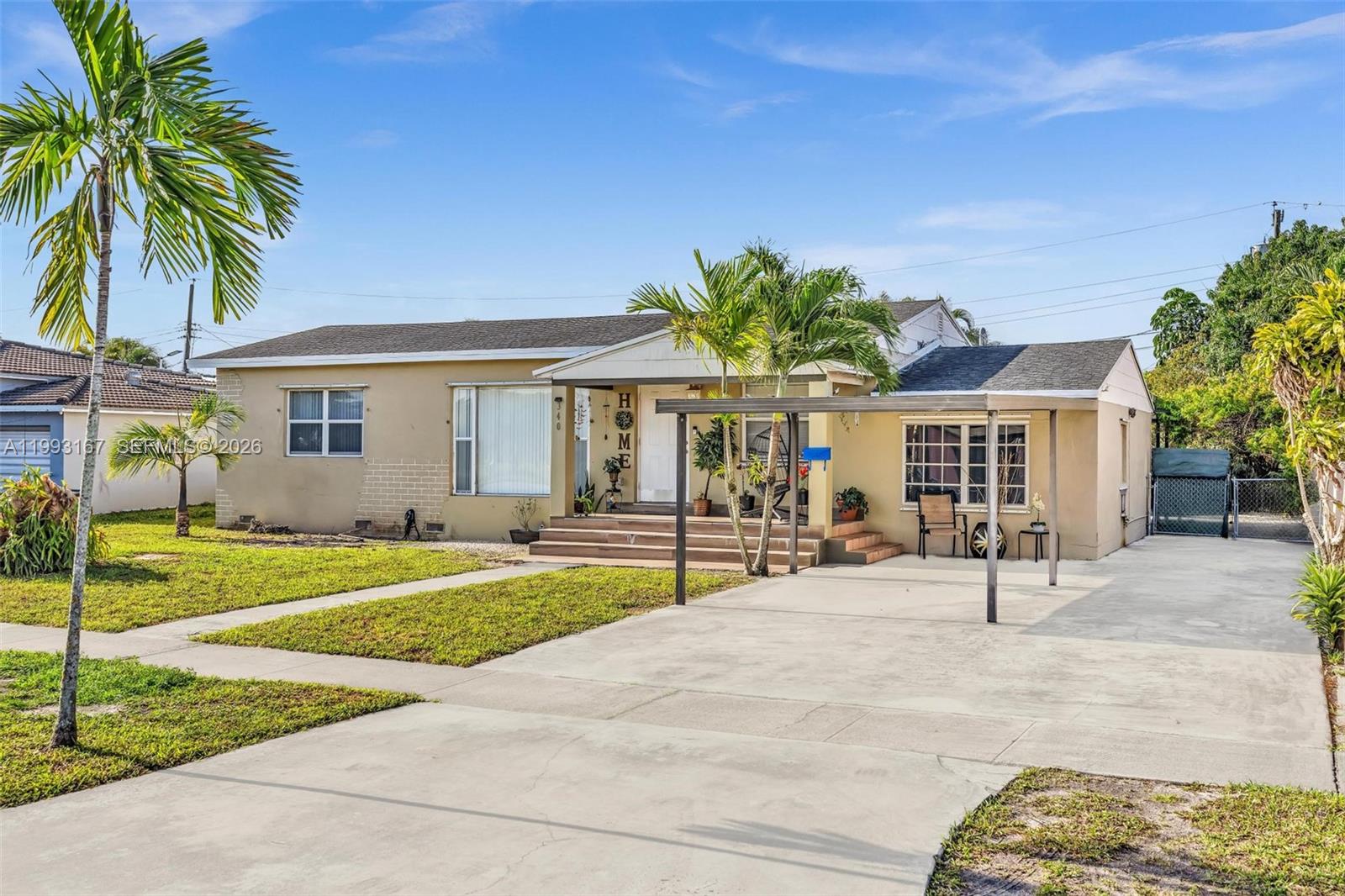 A single-story house features a concrete driveway, a covered porch, and palm trees — 340 W 55th St, Hialeah FL 33012, HIALEAH, FL