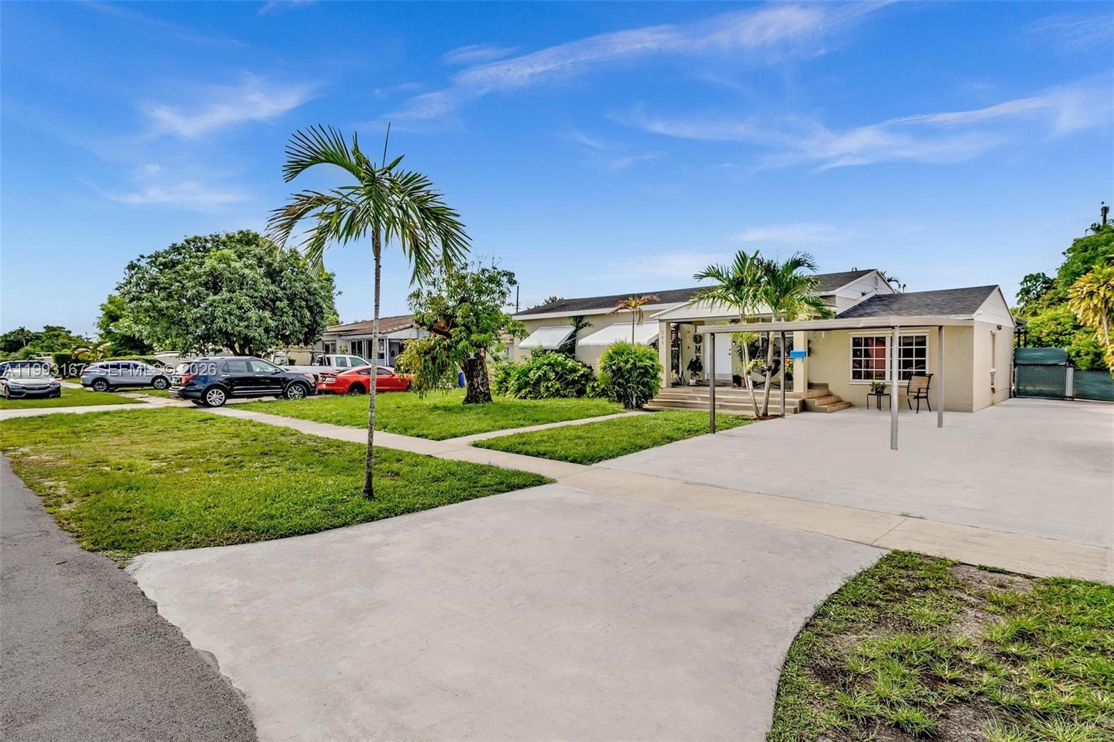 A single-story house with a concrete driveway, a covered carport, and a front lawn — 340 W 55th St, Hialeah FL 33012, HIALEAH, FL