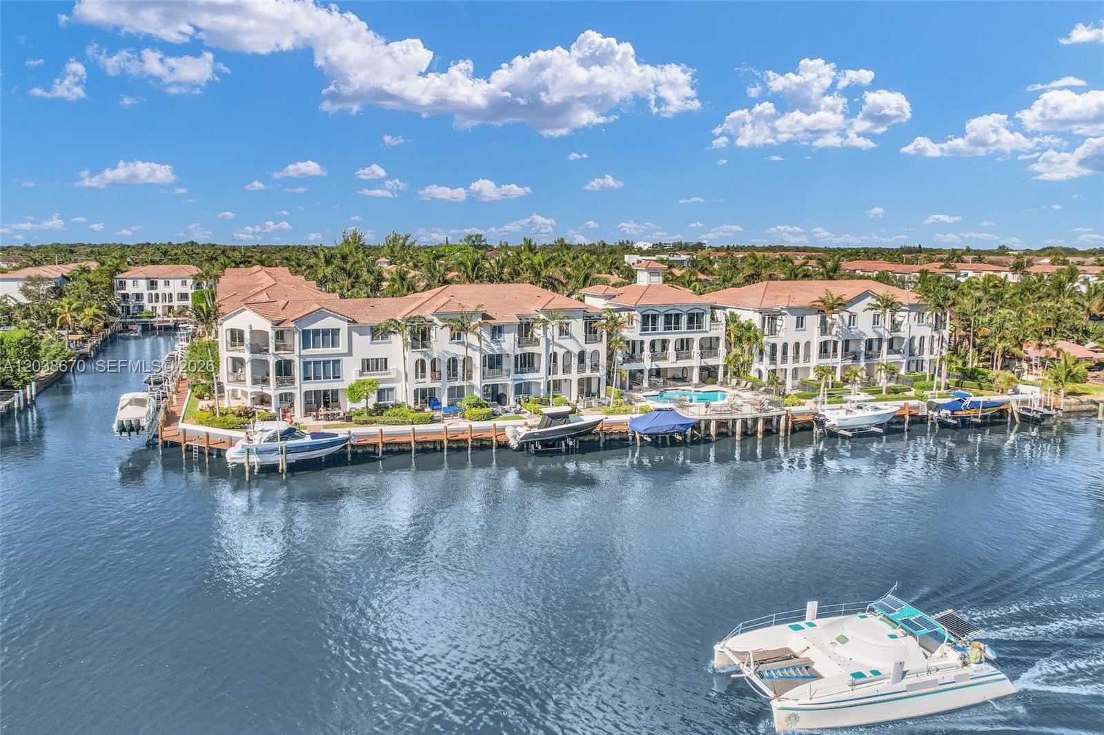 An aerial view shows a waterfront residential complex with boat docks and a swimming pool — 3127 Waterside Cir, Boynton Beach FL 33435, BOYNTON BEACH, FL