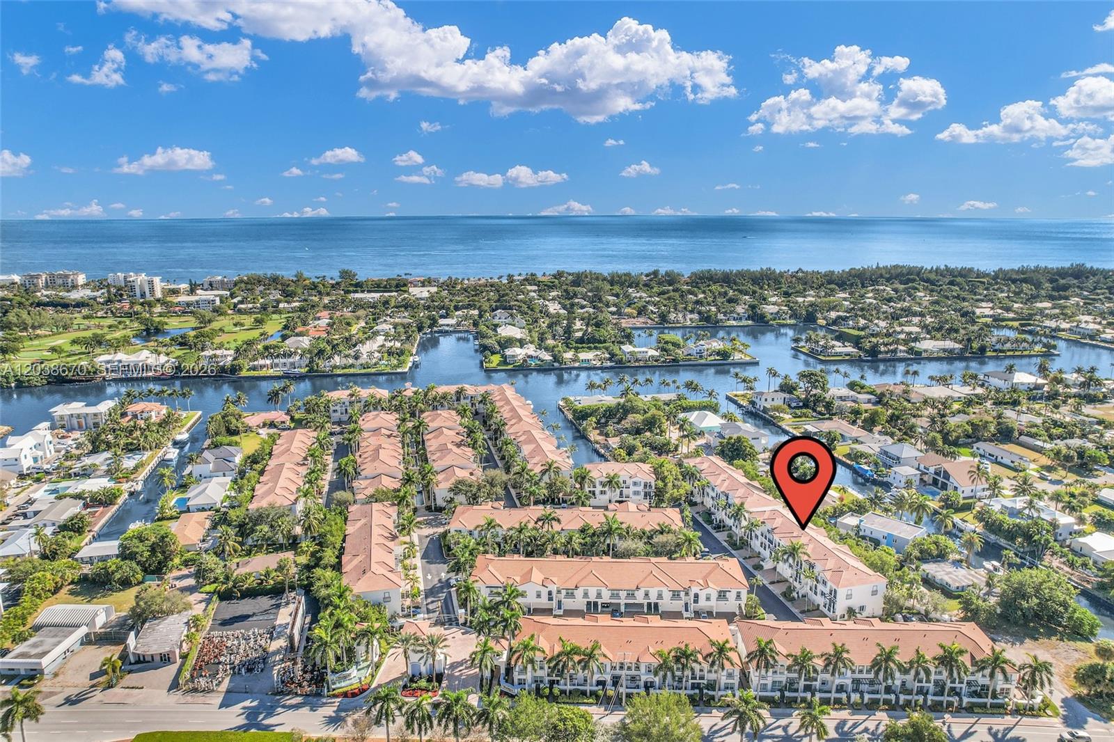 This aerial view shows a residential townhouse complex with tile roofs near the ocean — 3127 Waterside Cir, Boynton Beach FL 33435, BOYNTON BEACH, FL