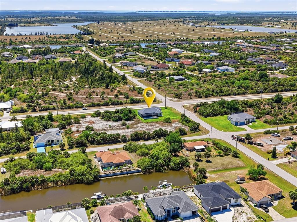 An aerial view shows a single-family home marked by a yellow pin in a neighborhood — 14364 APPLETON BOULEVARD, PORT CHARLOTTE, FL