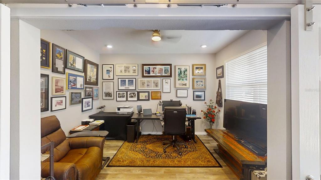 A home office features a desk, leather chair, area rug, and numerous framed wall pictures — 5655 SW 78TH AVENUE ROAD, OCALA, FL
