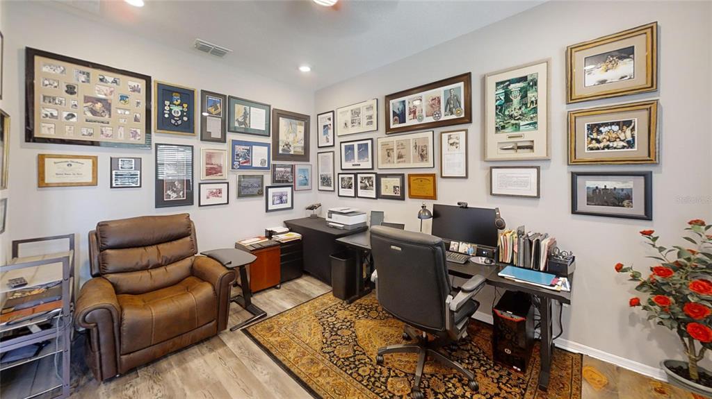 A home office features a leather recliner, a desk with a computer, and numerous framed pictures — 5655 SW 78TH AVENUE ROAD, OCALA, FL