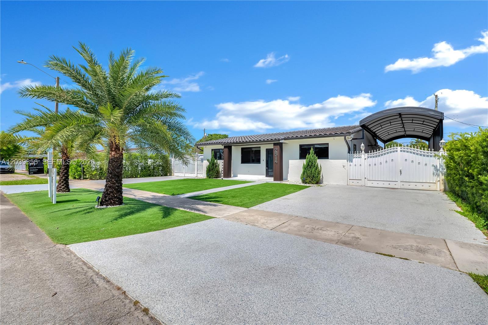 A single-story house features a white exterior, a paved driveway, a carport, and palm trees — 2914 SW 103rd Ct, Miami FL 33165, MIAMI, FL