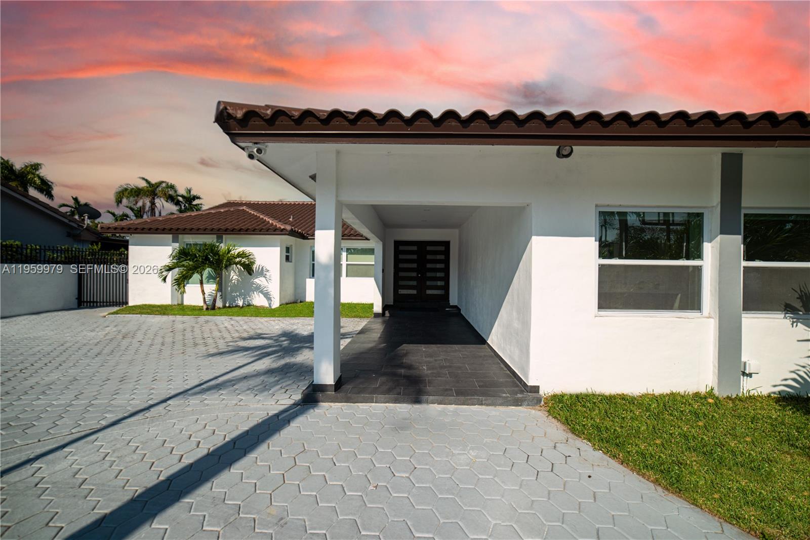 A white house exterior features a covered entryway, a tiled driveway, and a brown roof — 3500 SW 111th Ave, Miami FL 33165, MIAMI, FL
