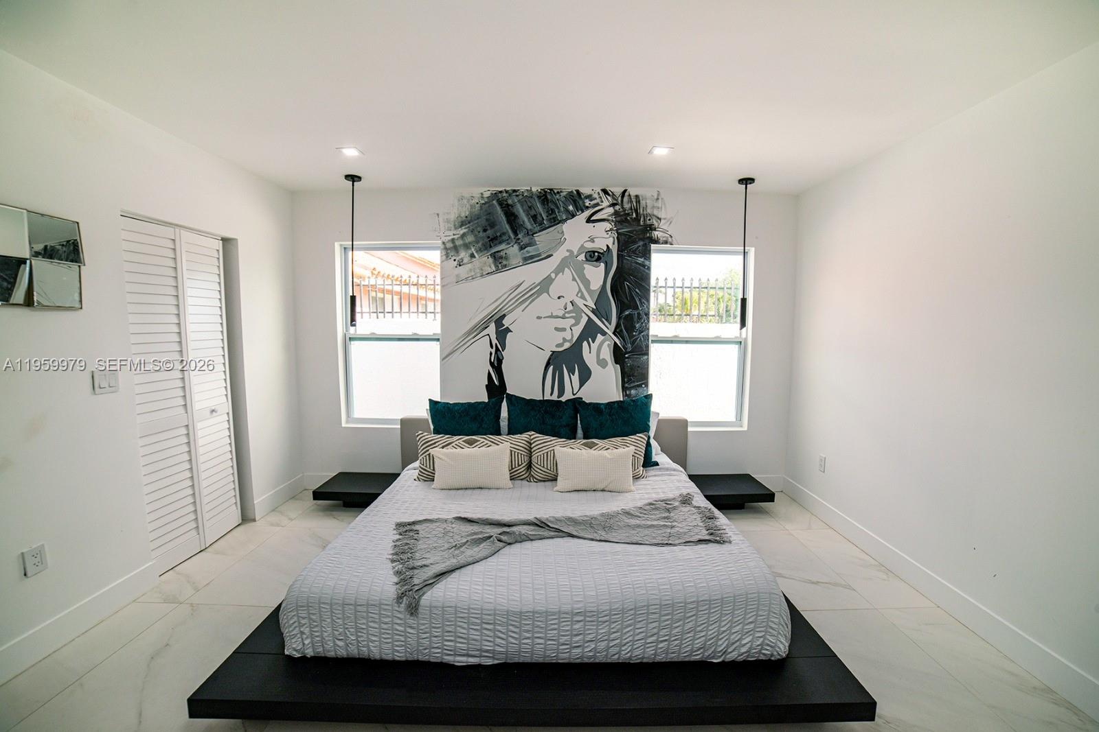 A bedroom features a platform bed, a large mural, and white tile flooring — 3500 SW 111th Ave, Miami FL 33165, MIAMI, FL