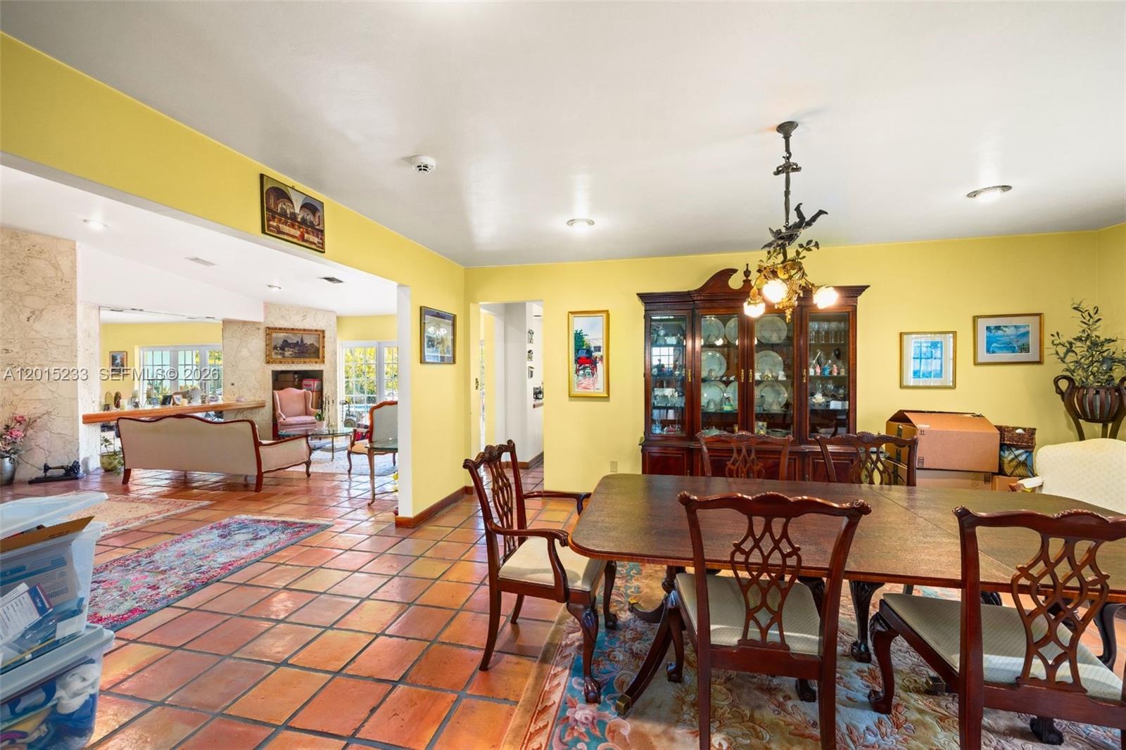 A dining room with a wooden hutch and table opens into a living area — 21141 NE 21st Ct, Miami FL 33179, MIAMI, FL