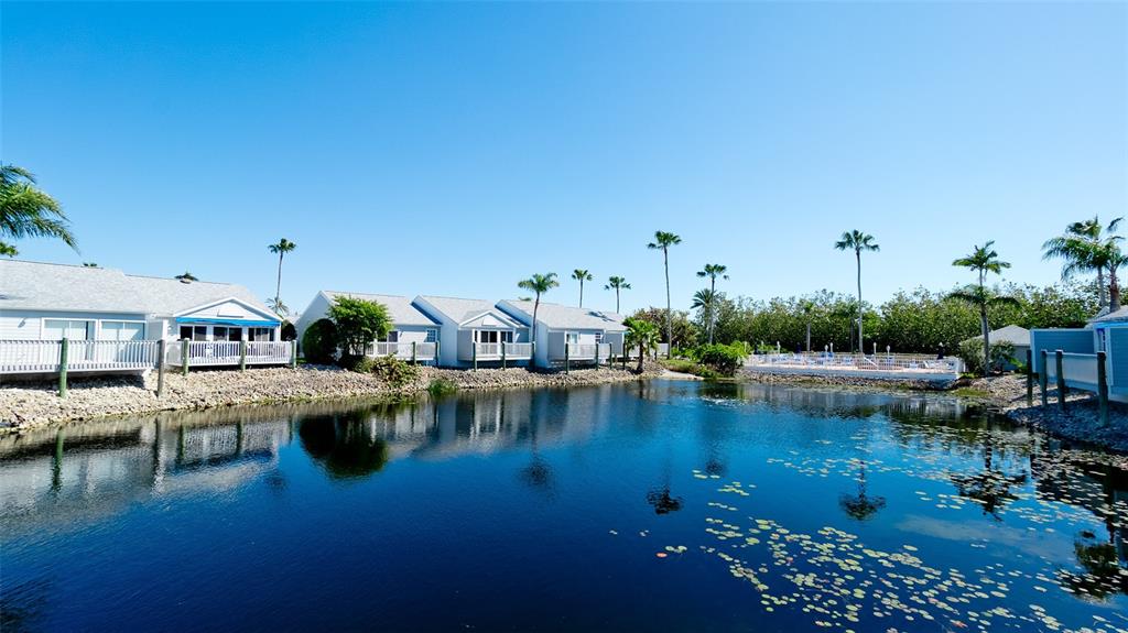 The exterior of a house features light gray siding, a garage door, and a walkway — 507 SANDERLING CIRCLE, BRADENTON, FL