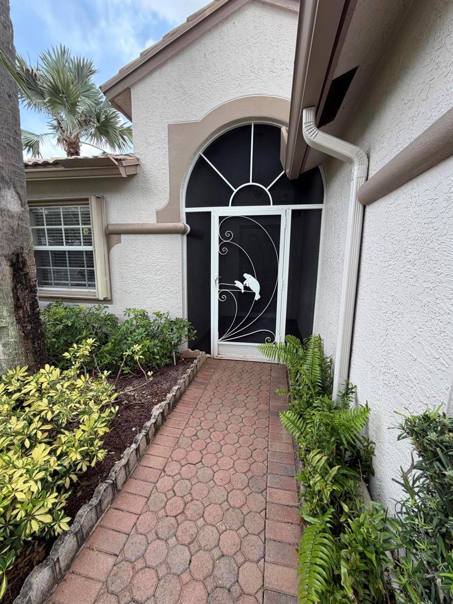 A single-story house with a tiled roof, a two-car garage, and a paved driveway — 8046 Florenza Drive, Boynton Beach FL 33472, BOYNTON BEACH, FL