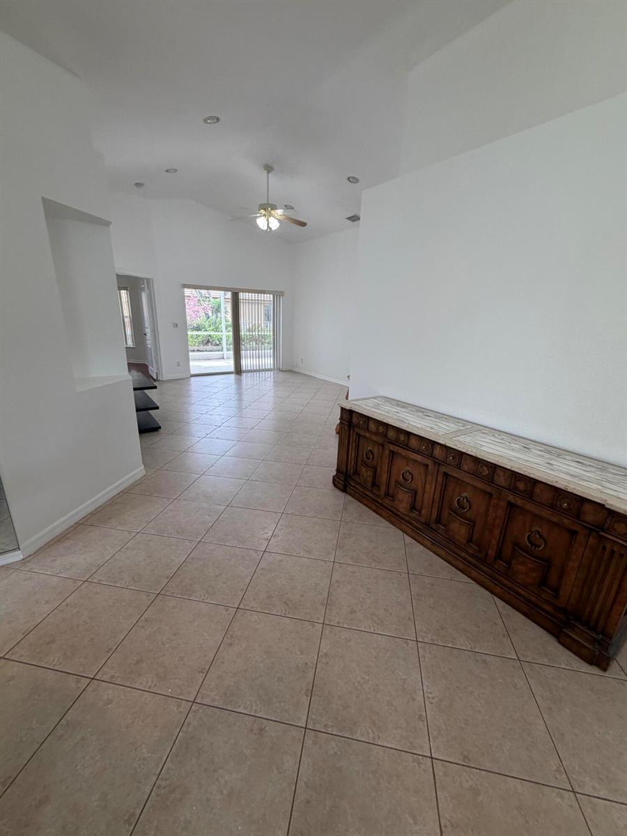 A paved walkway leads to the front entrance of a house with a decorative screen door — 8046 Florenza Drive, Boynton Beach FL 33472, BOYNTON BEACH, FL