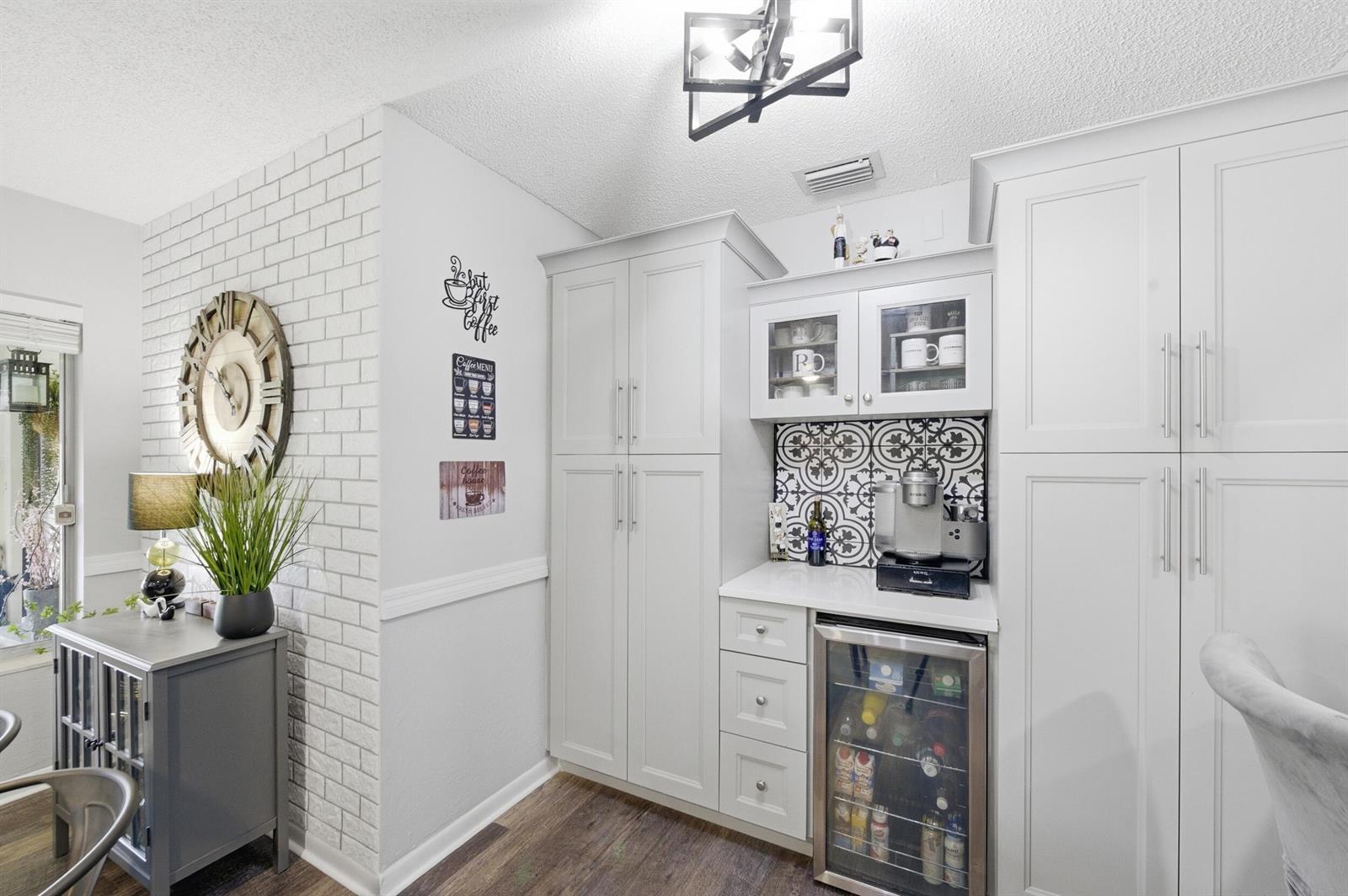 A kitchen coffee bar features white cabinetry, a patterned tile backsplash, and a beverage refrigerator — 5883 La Paseos Drive # 2, FL 33463, FL