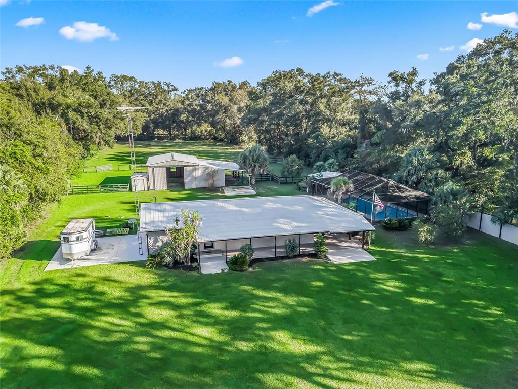 A single-story house with a metal roof and attached carport sits on a grassy lawn — 3505 NE 97TH STREET ROAD, ANTHONY, FL