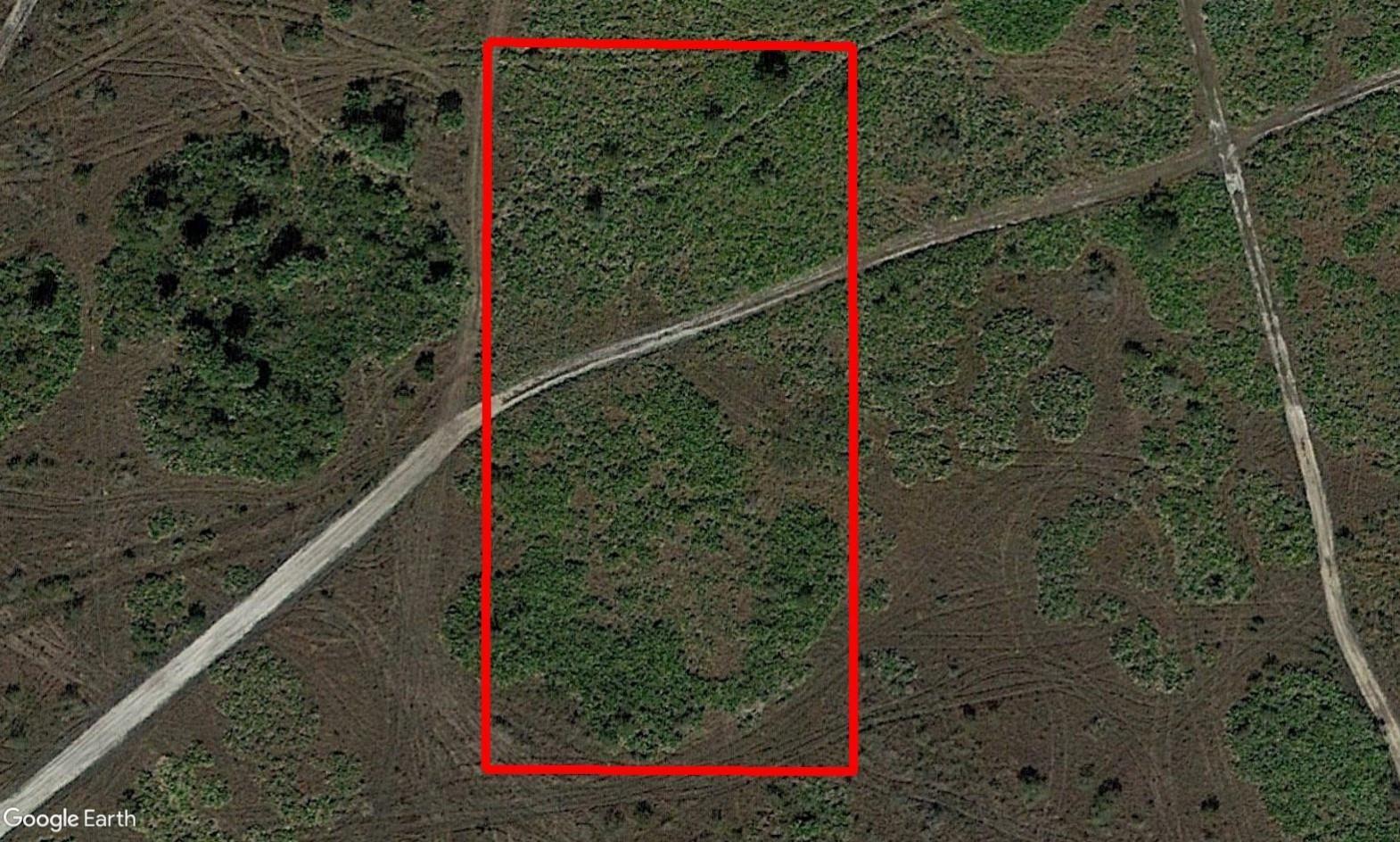 An aerial view shows a rectangular plot of land outlined in red on grassy terrain — 0 NW 310th Street, Okeechobee FL 34972, OKEECHOBEE, FL