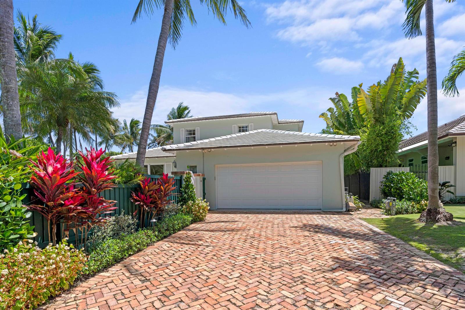 A light green house with a white garage door and a brick driveway — 1554 N Ocean Way, Palm Beach FL 33480, PALM BEACH, FL