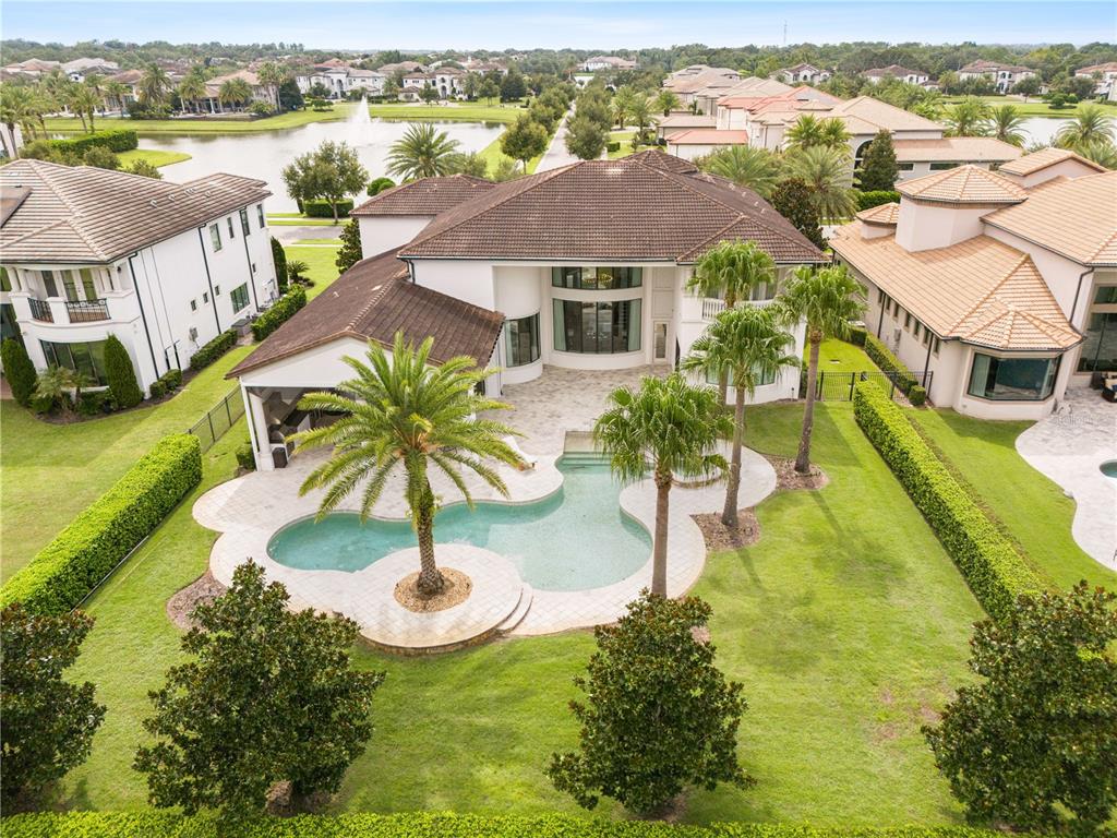 An aerial view of a two-story house with a pool, patio, and palm trees — 4201 ISABELLA CIRCLE, WINDERMERE, FL