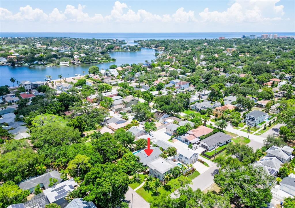 An aerial view shows a residential neighborhood with a red arrow pointing to a house — 182 29TH AVENUE N, ST PETERSBURG, FL
