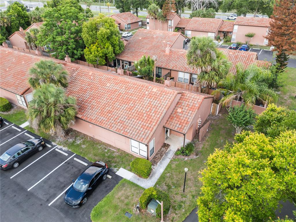 An aerial view shows a single-story residential building with a tiled roof and adjacent parking — 652 SAINT JHONS UNIT 652, WINTER PARK, FL