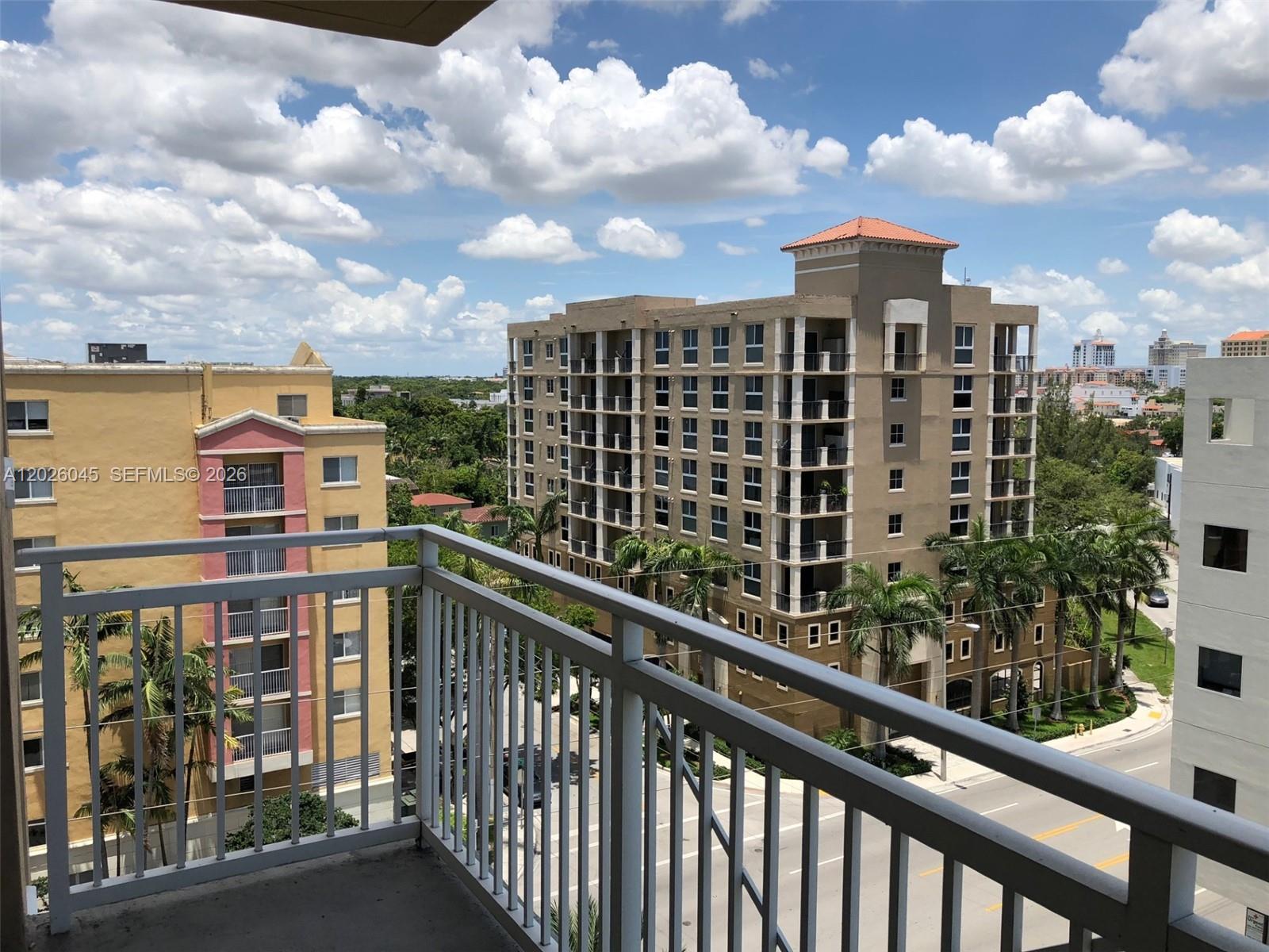 A view from a balcony overlooking a street and surrounding apartment buildings — 2665 SW 37th Ave # 814, Miami FL 33133, MIAMI, FL