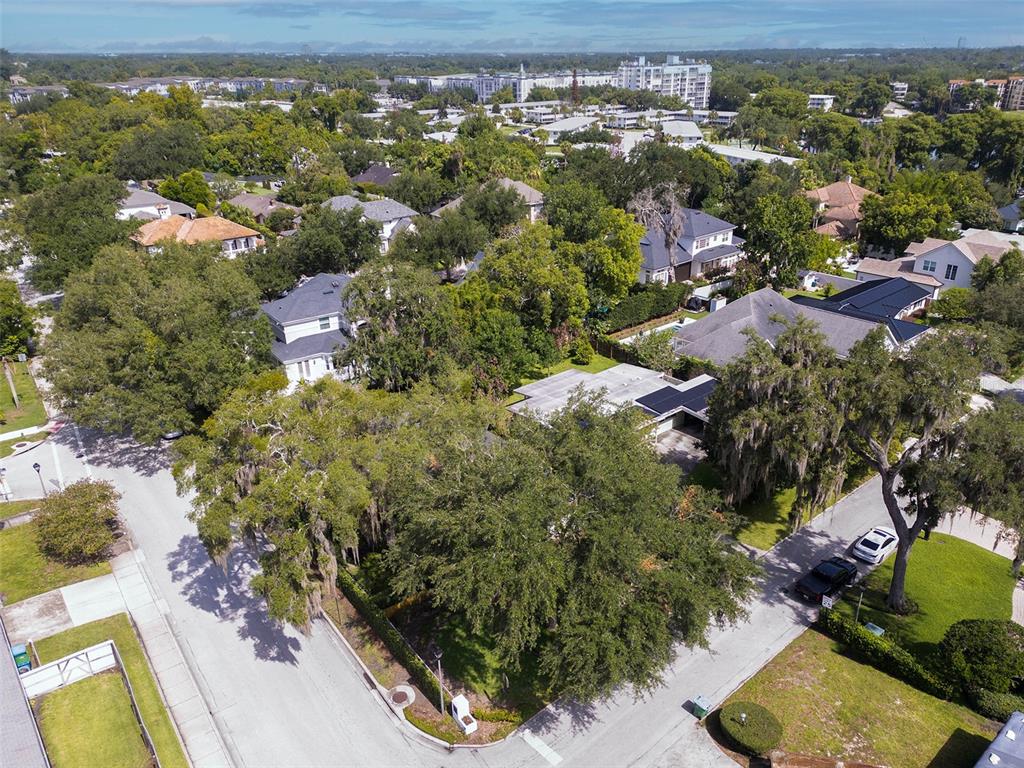 An aerial view shows a suburban neighborhood with houses, mature trees, and paved streets — 1361 AUDUBON ROAD, MAITLAND, FL