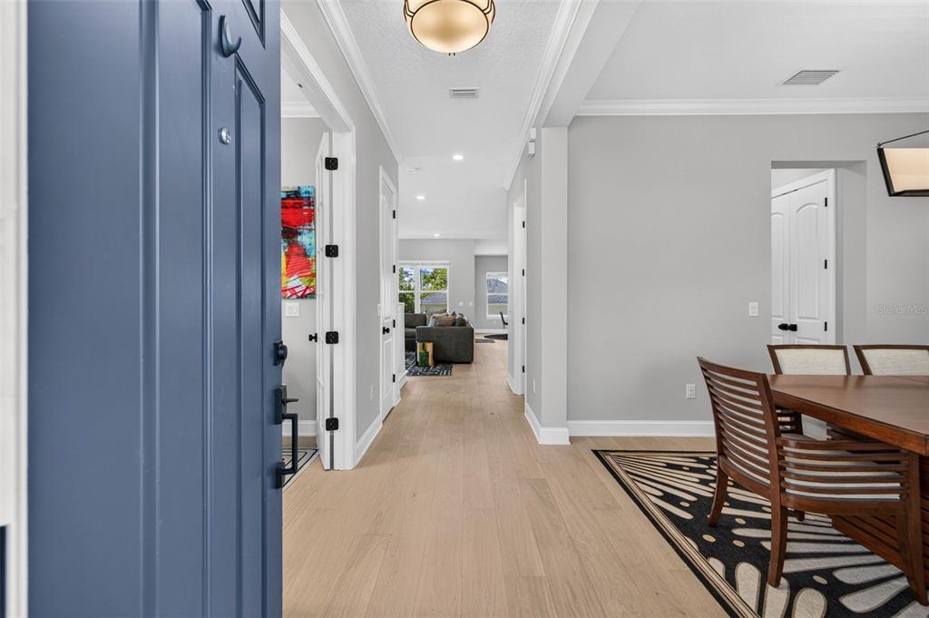A view from an entryway looking down a hallway toward a living room — 293 18TH AVENUE S, ST PETERSBURG, FL