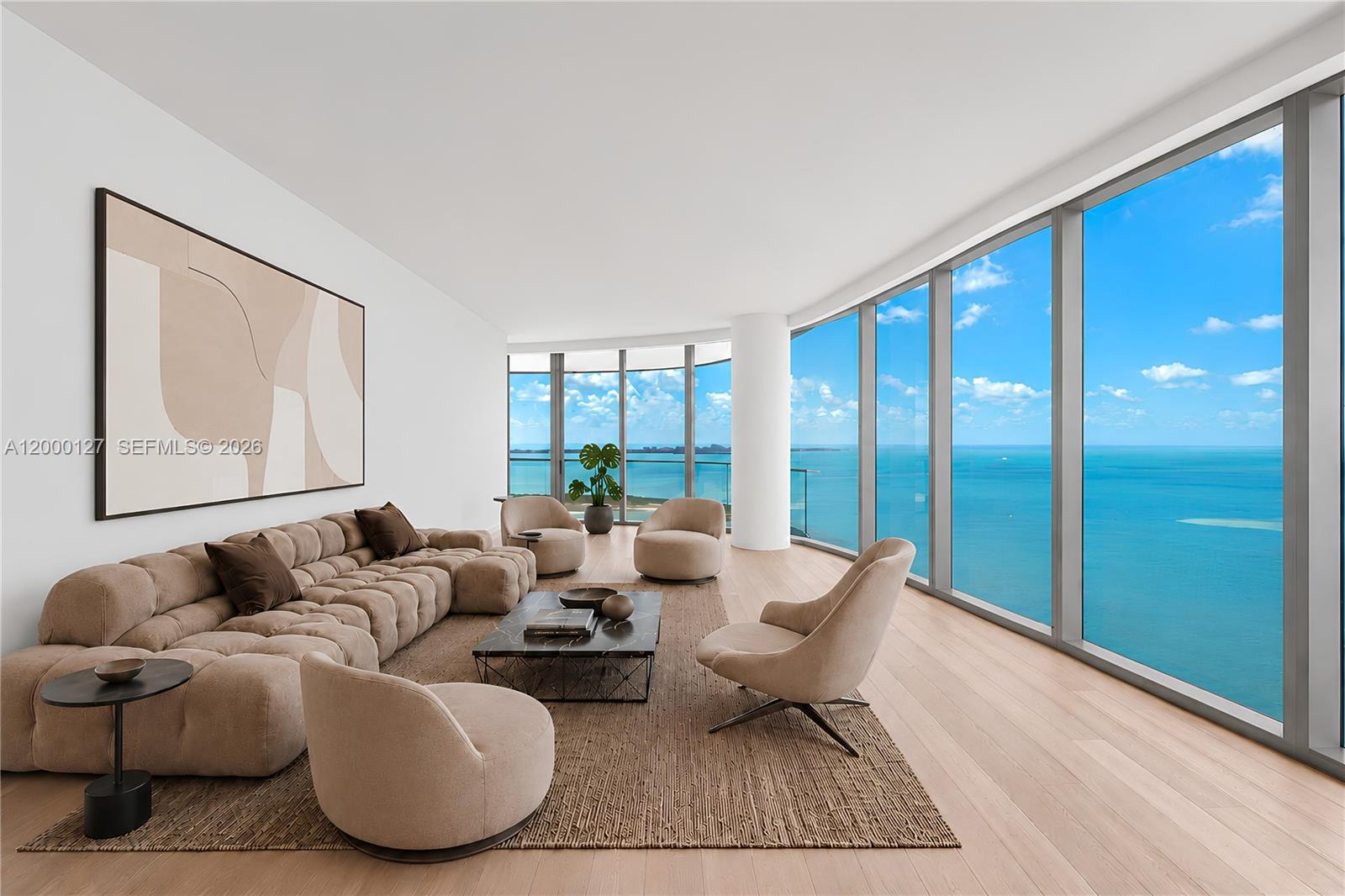 A modern kitchen features wood cabinetry, a stone waterfall island, and a view of water — 175 SE 25th Road # 3602, Miami FL 33129, MIAMI, FL