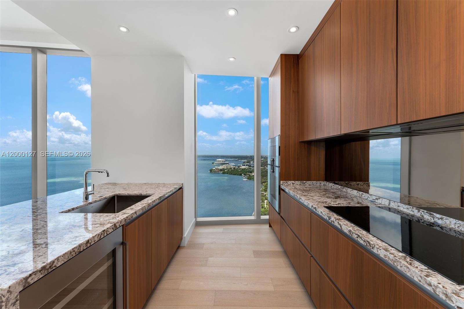 A modern bedroom features a king bed, neutral decor, and floor-to-ceiling windows overlooking the ocean — 175 SE 25th Road # 3602, Miami FL 33129, MIAMI, FL