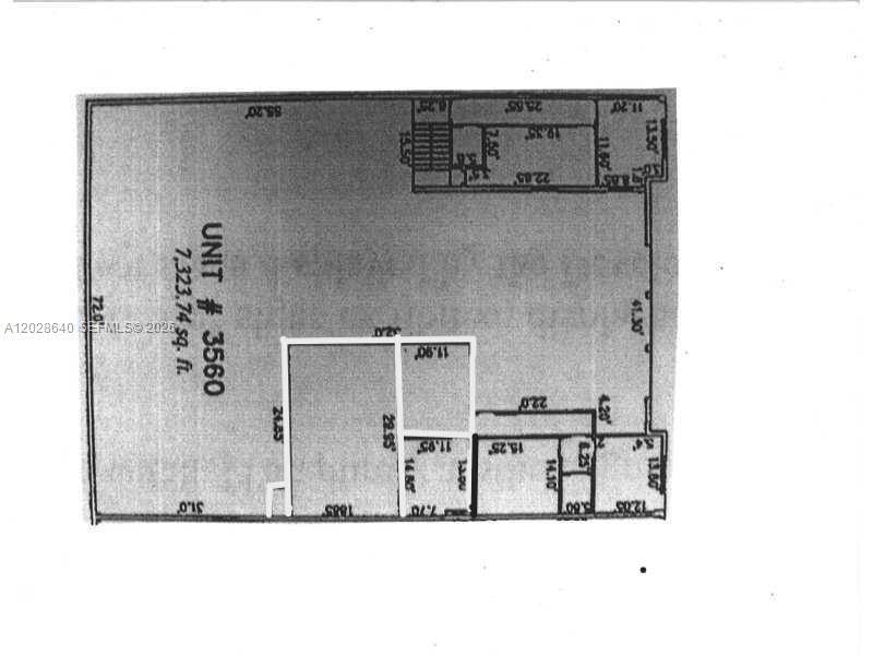 An empty warehouse space features a high ceiling with a large fan and concrete floors — 3560 NW 115th Ave # 3560, Doral FL 33178, DORAL, FL
