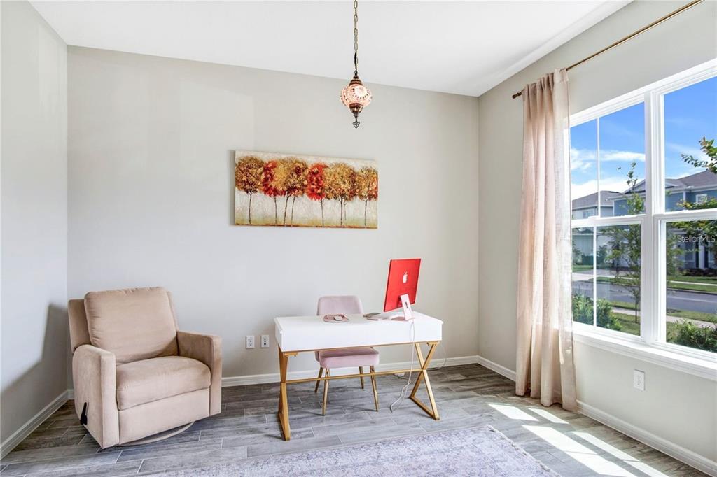 A home office features a desk, a recliner, a pendant light, and a large window — 13348 PANAMA BEACH COURT, ORLANDO, FL