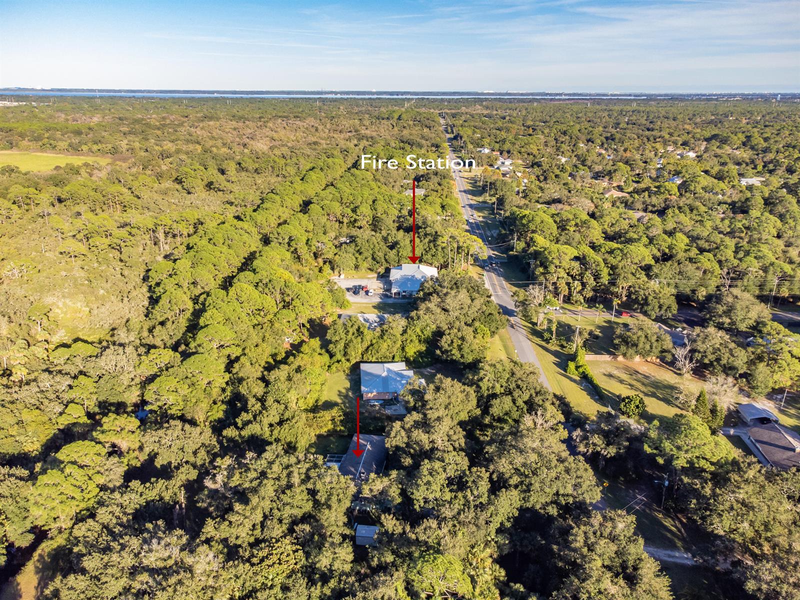 An aerial view shows a road, dense forest, and several buildings, including a fire station — 4022 Canaveral Groves Boulevard, Cocoa FL 32926, COCOA, FL