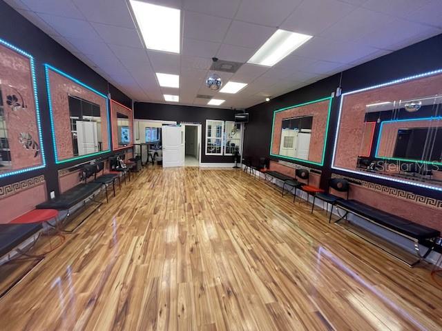 A dance studio features wood flooring, mirrored walls with LED lighting, and bench seating — 160 CYPRESS POINT PARKWAY UNIT C212, PALM COAST, FL