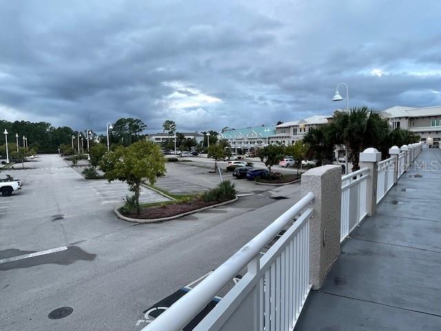 An elevated view of a parking lot and surrounding buildings under a cloudy sky — 160 CYPRESS POINT PARKWAY UNIT C212, PALM COAST, FL