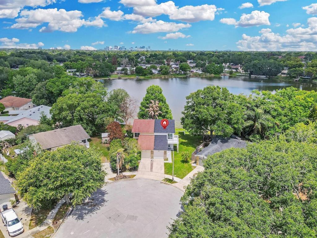 An aerial view shows a two-story duplex with a lakefront backyard and a cul-de-sac — 3058 GRACELAND COURT, ORLANDO, FL