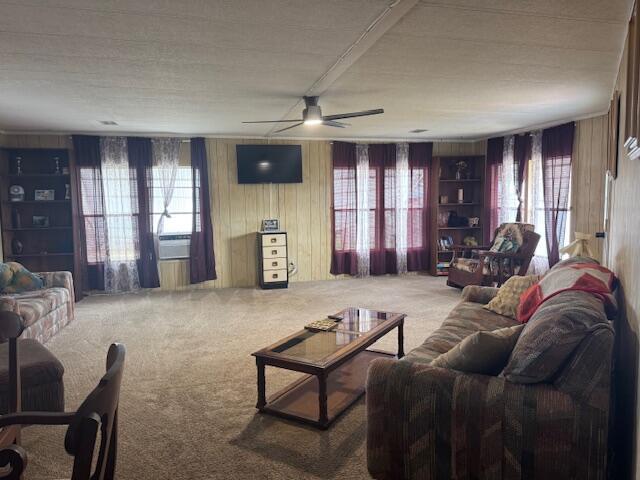 A living room features wood-paneled walls, carpeted flooring, a ceiling fan, and two large windows — 1065 Echo Avenue, Moore Haven FL 33471, MOORE HAVEN, FL