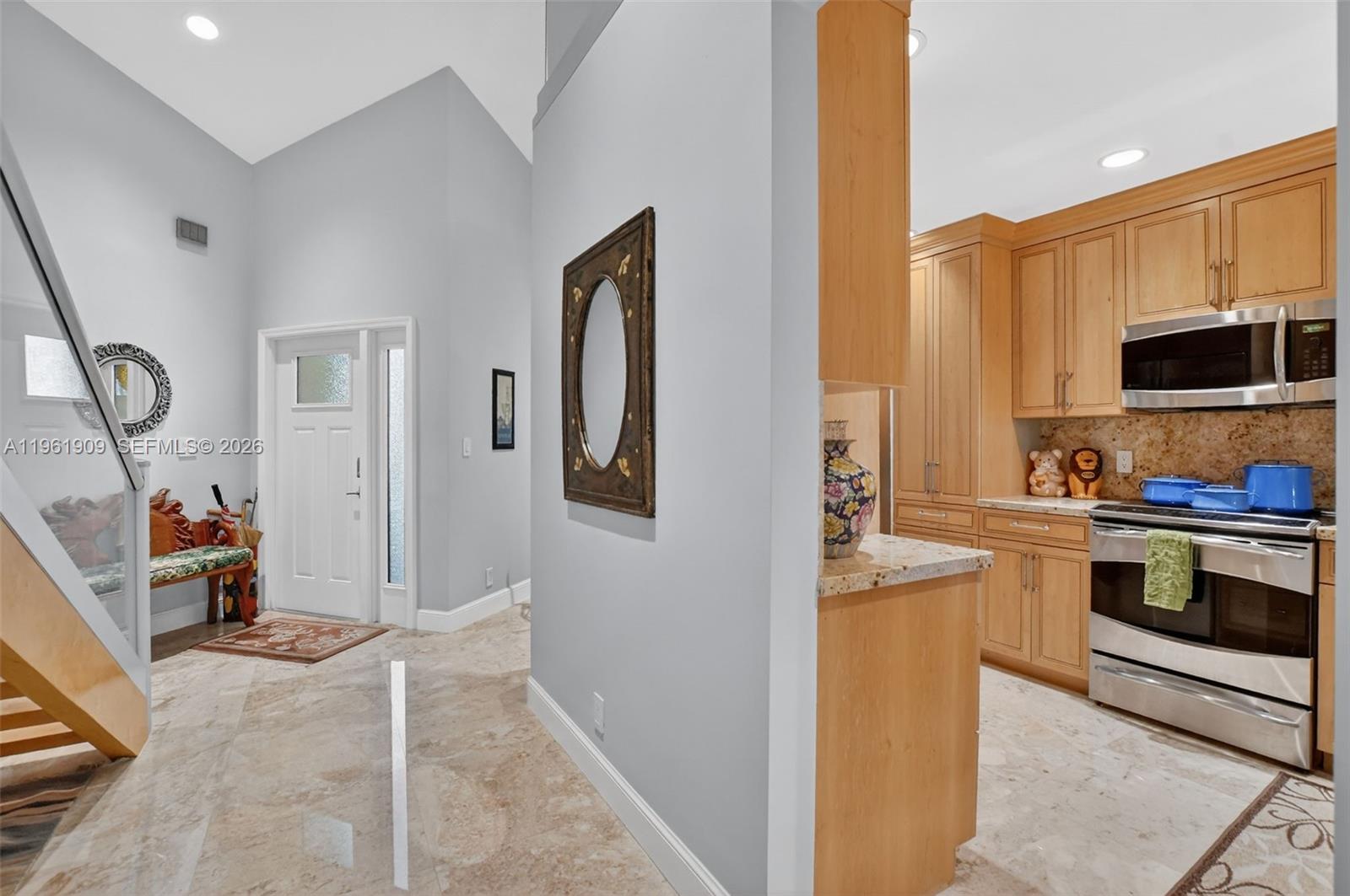 A view of a home entryway with a staircase and an adjacent kitchen — 1400 NW 9th Ave # 2, Boca Raton FL 33486, BOCA RATON, FL